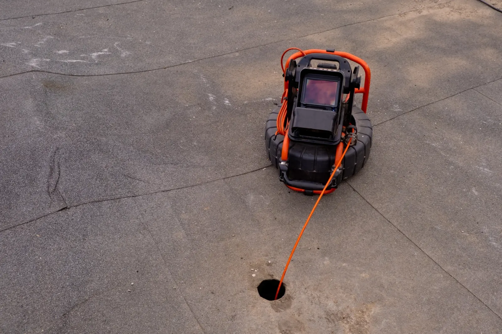 CCTV drain camera being fed into a sewer line