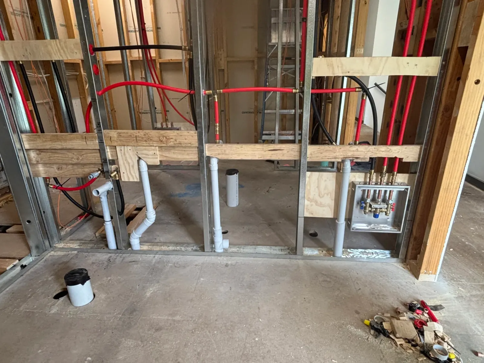 Rough-in pipework framed in a wall before lining