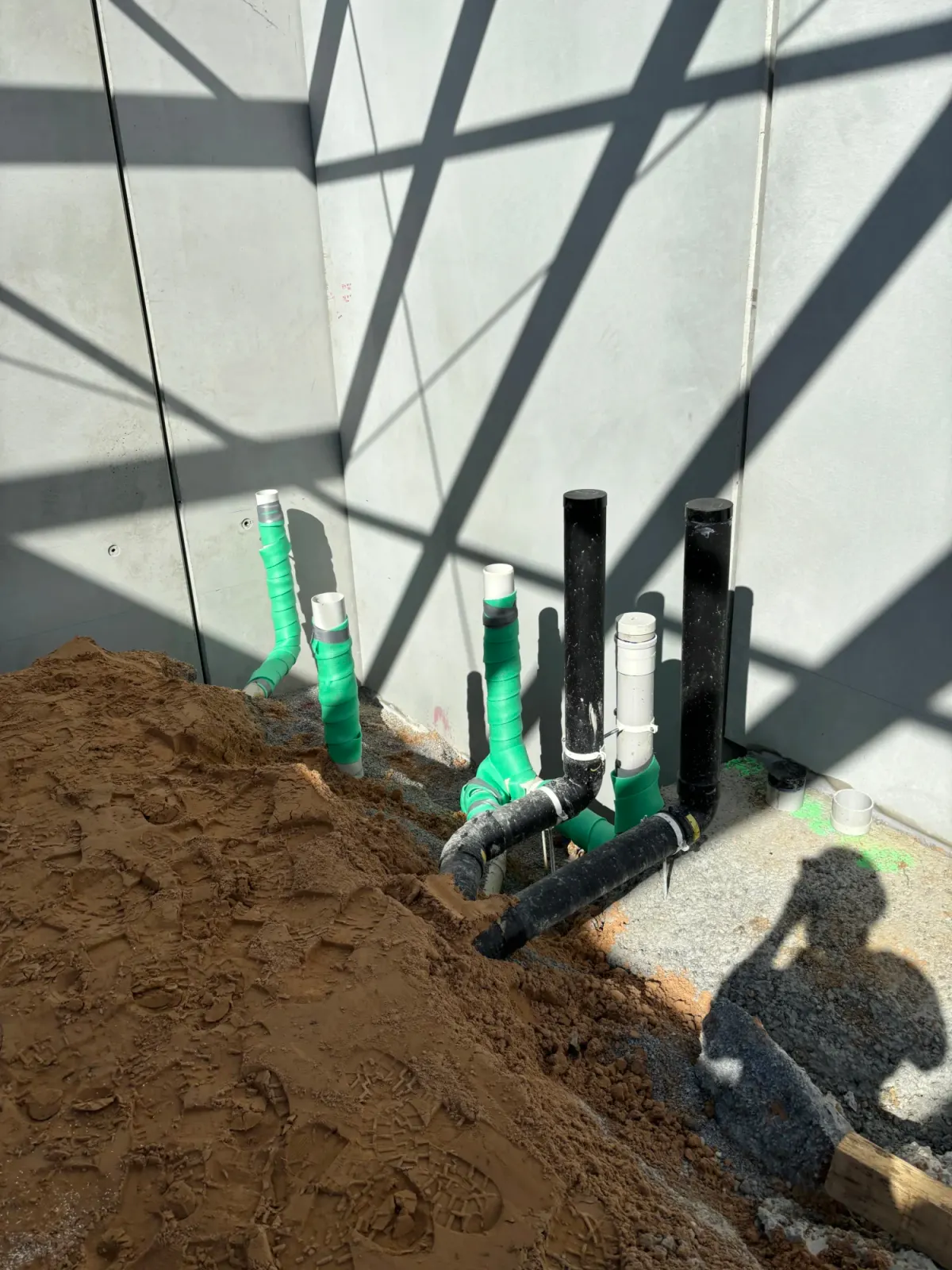 Sewer and grease waste drains laid in the ground before a commercial kitchen slab is poured