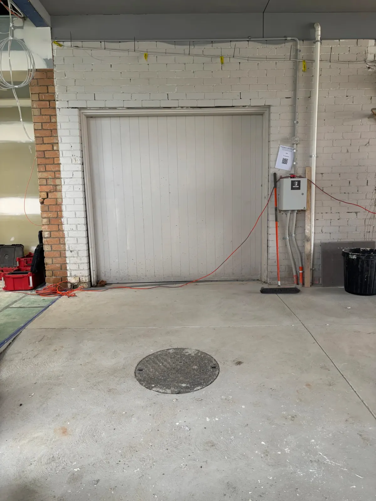 Finished in-ground sewer tank with the lid and risers set flush before the surface is reinstated